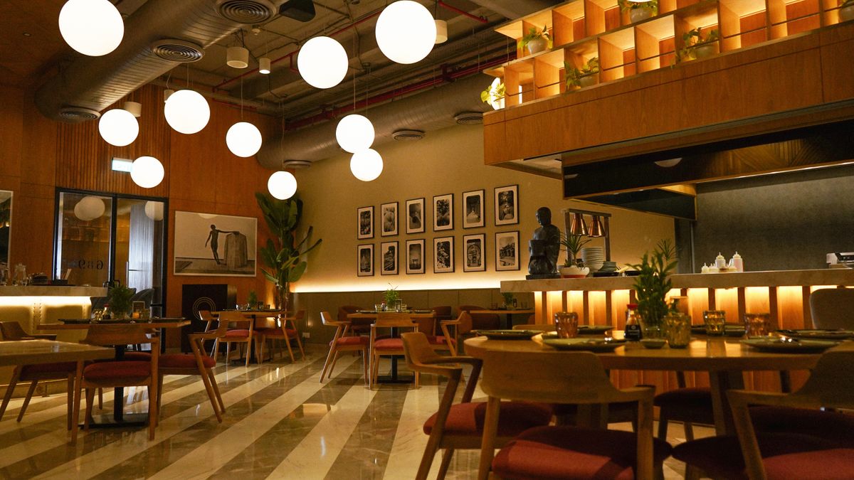 Warm modern restaurant interior with tables and ambient lighting